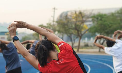 Group of people smiling after a morning exercise session outdoors